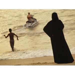  Middle Eastern Woman Watches Jet Skier from Penang Beach 