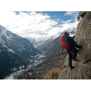  A Man on a Via Ferrata Route High Above the Tiny Village 