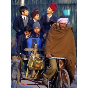  Indian Children Ride to School on the Back of a Cycle 