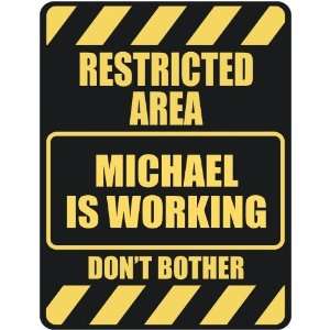   RESTRICTED AREA MICHAEL IS WORKING  PARKING SIGN