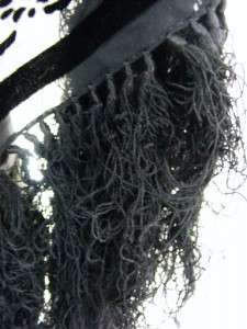 The fringe on the shawl is very tangled, and there is one small pull 