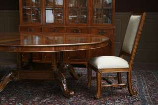 Large round mahogany table shown with 10 Chippendale chairs.