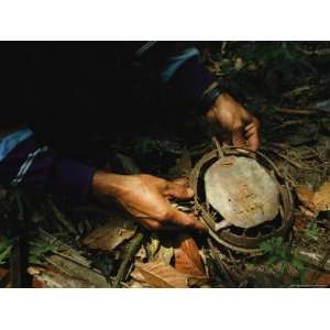  A Burmese Man Holding a Steel Animal Trap in His Hands 