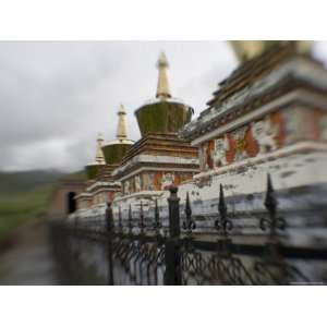 Stupas Behind a Wrought Iron Fence at a Monastery, Qinghai, China 