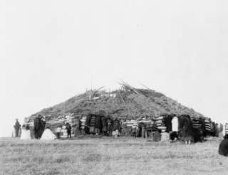 Description 1911 photo Log building with sod roof with Indians 
